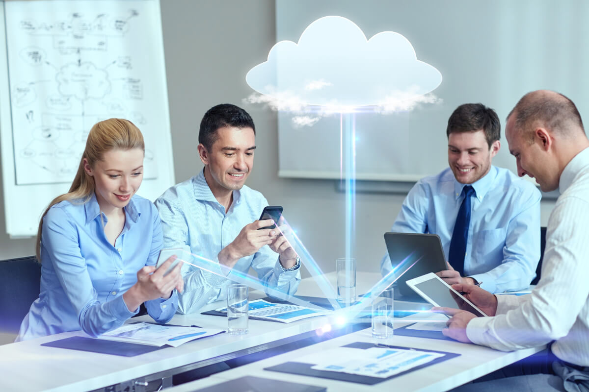 Four co-workers having data beamed to them from the cloud 