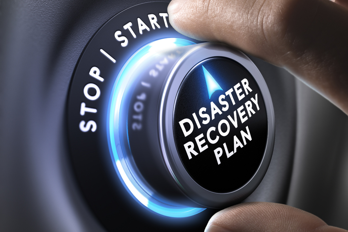 Fingers on a button that reads disaster recovery plan