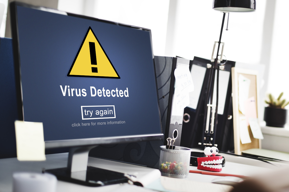 A monitor with a virus alert on the screen