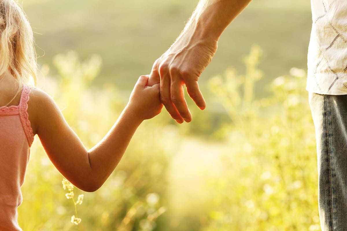 Man and little girl holding hands