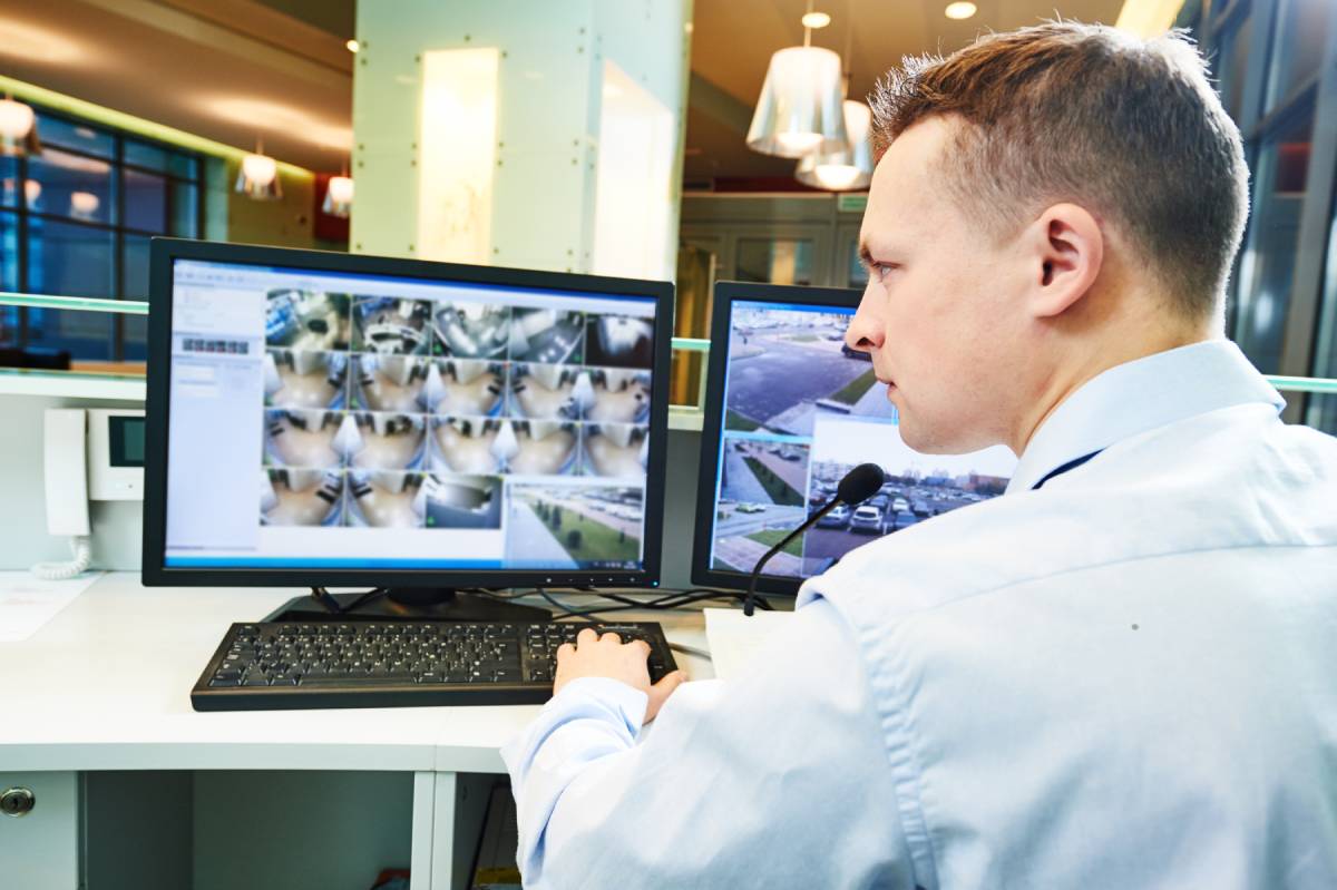An employee looking at video feeds from CCTV cameras