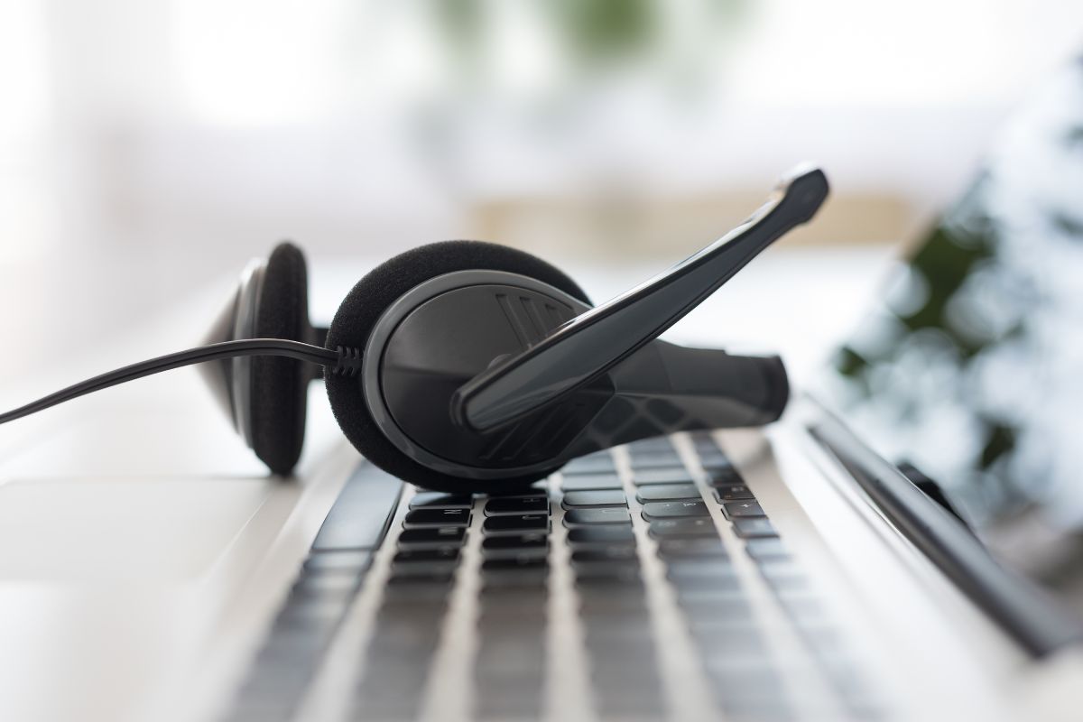 A headset resting on a laptop keyboard