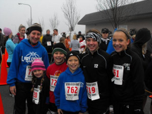 A line up of smiling runners with their numbers for Southern Oregon Turkey Trot tapped on their chest